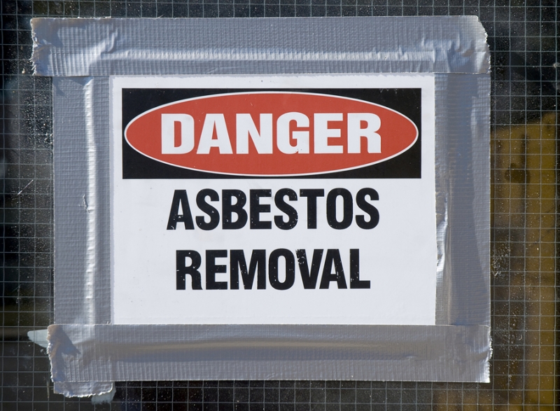 Danger Asbestos Removal Sign posted on school window.