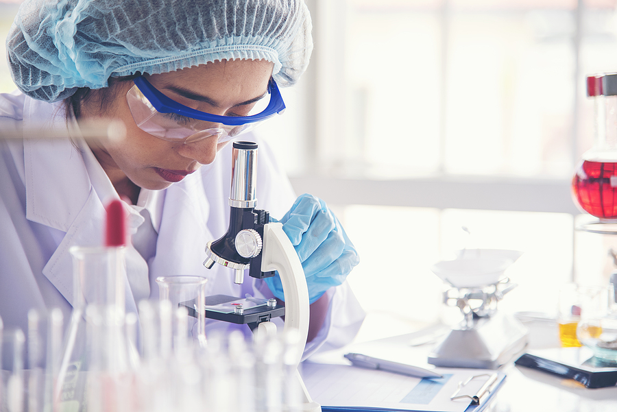 Asian Woman Scientist Hand Write Note Research In Medical Lab Lo