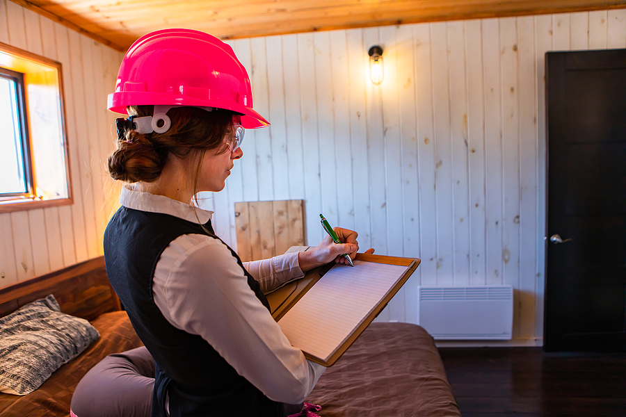 Construction Inspector Woman Writes Notes Using A Clipboard, Bed