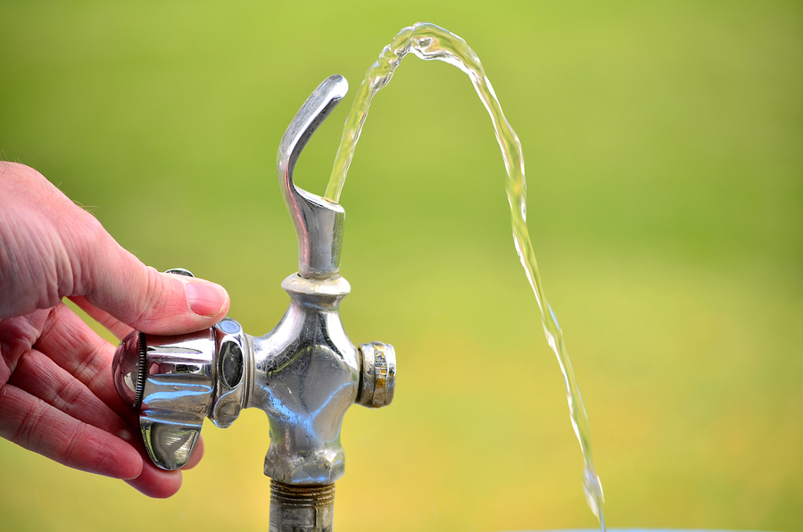 Drinking fountain in park with water flowing