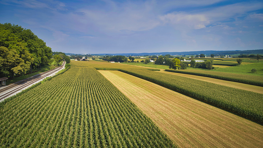 Drone View Of Amish Countryside With Barns And Silos And A Singl