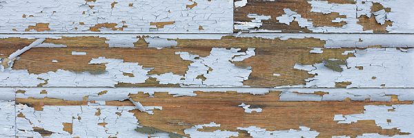 Cracking and peeling lead paint off of wood sliding.