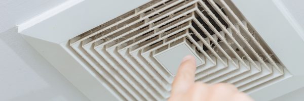 Finger Pointing At Dusty Dirty Ceiling Air Ventilation Fan Hole
