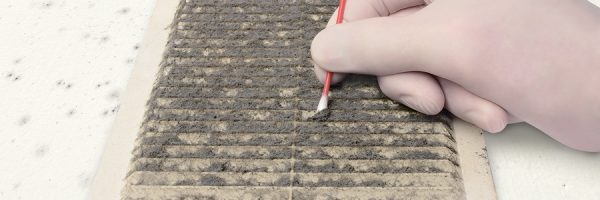 Person Gloved Check Ventilation In The Dirt With A Cotton Swab,