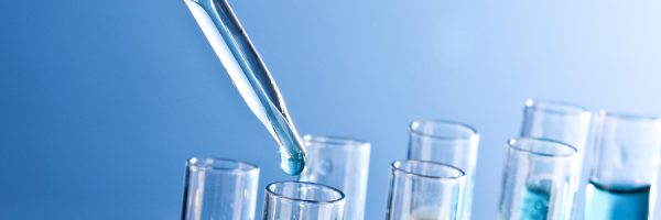 Test tubes closeup on blue background. Drops from test stick