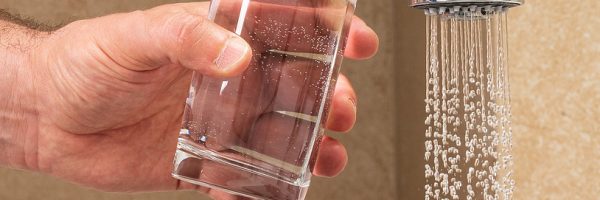 Man Getting A Glass Of Water From A Faucet.