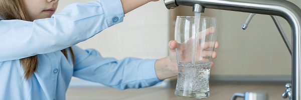 Child Open Water Tap. Kitchen Faucet. Glass Of Clean Water. Pour
